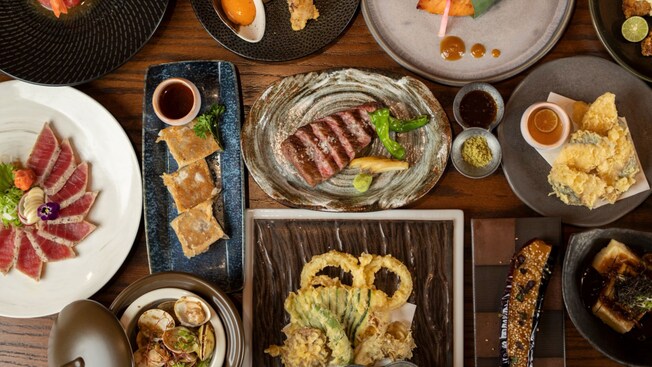 Several plates holding various Japanese delicacies