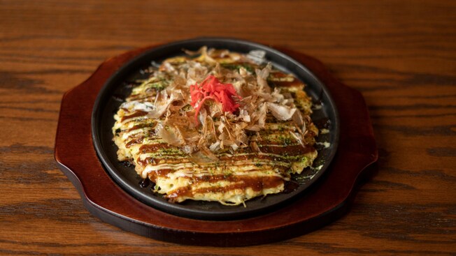A plate of Okonomiyaki, a Japanese pancake