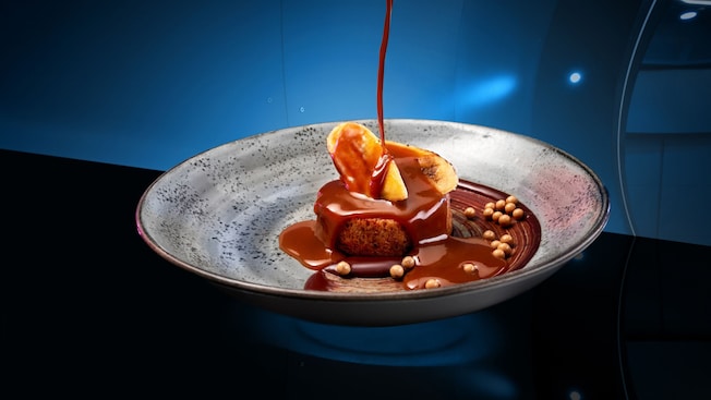 Salted toffee sauce being poured over a pudding cake