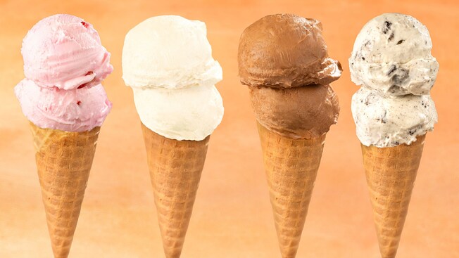 4 ice cream cones with different flavors including strawberry, vanilla, chocolate and cookies and cream
