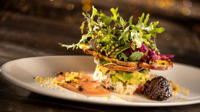 Olive bread, a citrus blend, capers and sauce on a plate