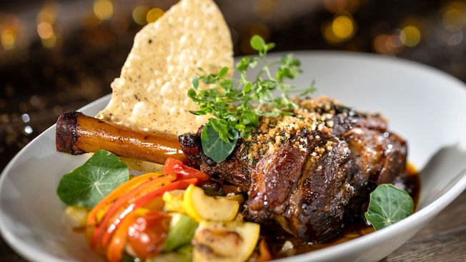 Lamb shank served with veggies on a plate
