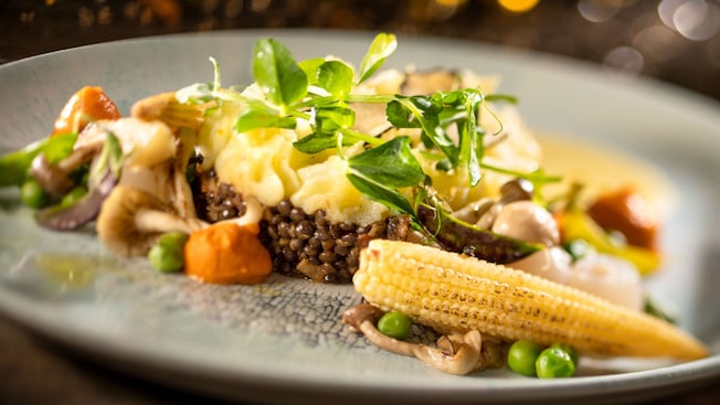 Mashed potatoes, mushrooms, peas and corn on a plate