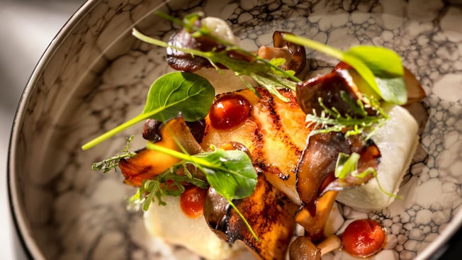 A Toothfish Bamboo Sambal topped with greens and mushrooms