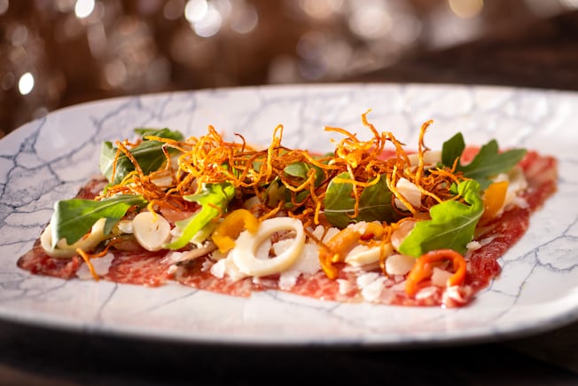 A platter of Beef Carpaccio from Yachtsman Steakhouse
