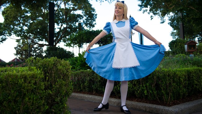 Alice strikes a pose in a garden