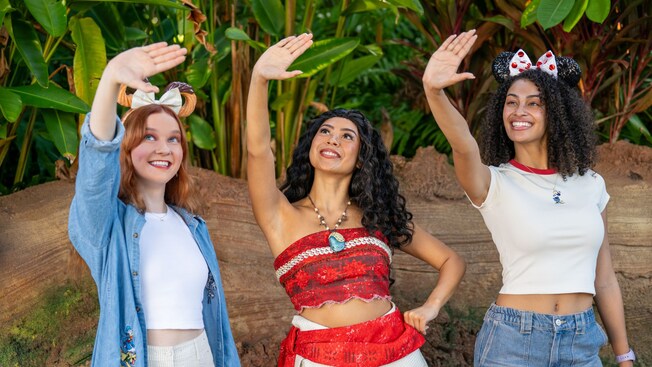 Moana and 2 Guests with Minnie Mouse ear headbands doing a hula at Discovery Island in Disney's Animal Kingdom theme park