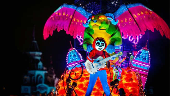 Miguel and Pepita from Coco on a float in the Disney Starlight, Dream the Night Away parade at Magic Kingdom park