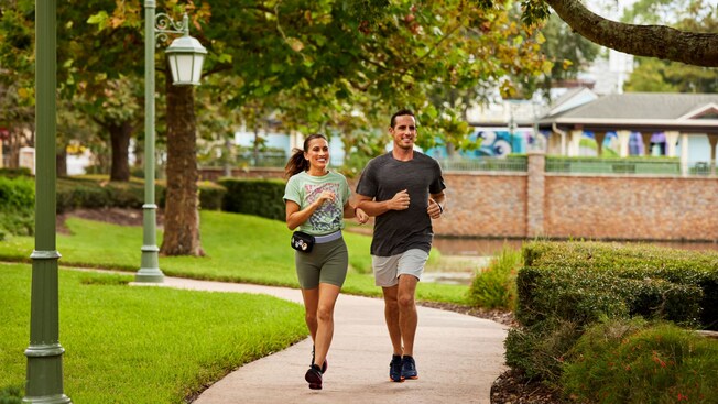 A man and a woman jogging on designated running trails at Walt Disney World Resort