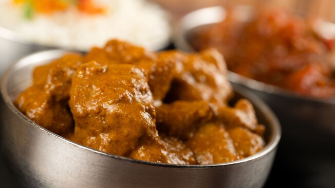 A bowl with butter chicken covered in sauce