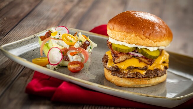 A double cheeseburger served with a side of vegetables