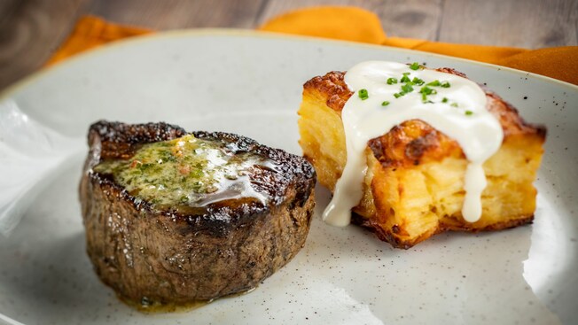 A 6-oz filet mignon served on a plate with a side dish