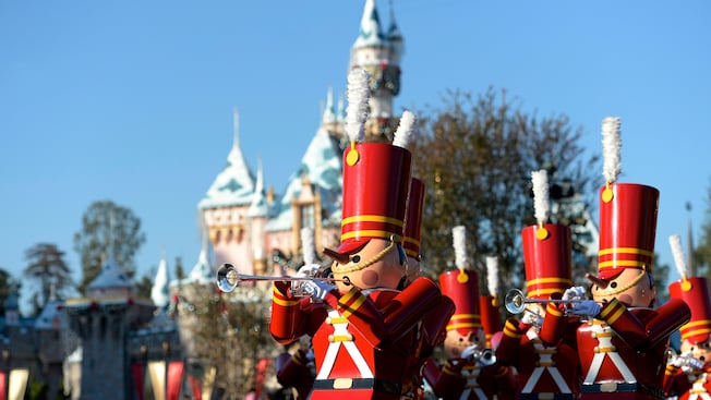 Toy soldiers, playing trumpets, marching down Main Street USA
