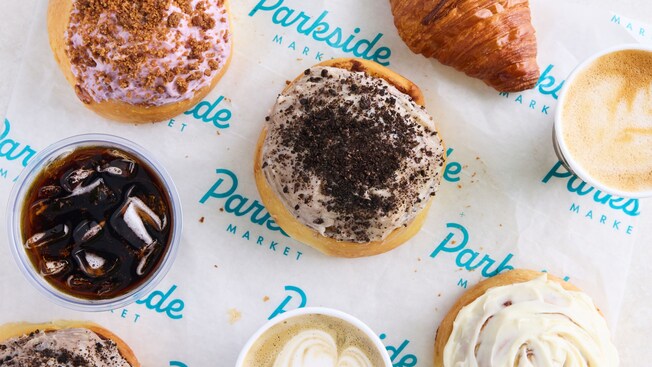 Four frosted donuts, 2 cappuccinos, a croissant and a drink from Sip & Sonder