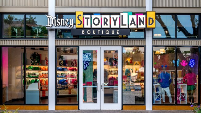 Exterior of Disney Storyland Boutique featuring a stylized sign and merchandise displays at the Downtown Disney District