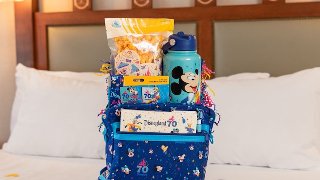 A Disneyland Resort 70th Celebration welcome basket on a Disneyland Resort hotel bed