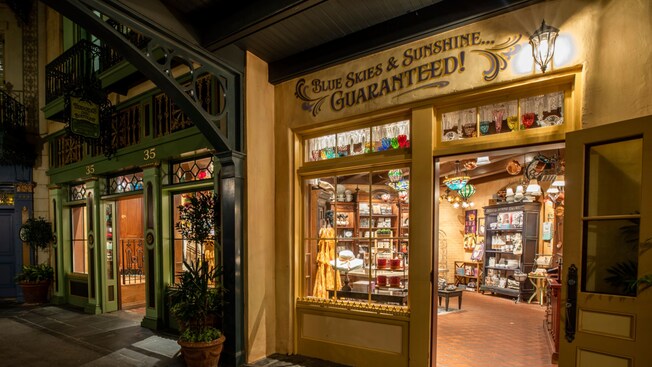 The facade of a New Orleans themed shop with the words 'Blue Skies & Sunshine Guaranteed' on the wall