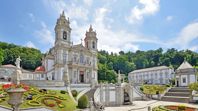 The Sanctuary of Bom Jesus do Monte, an historic Catholic church with a decorative garden and ornate staircases in front
