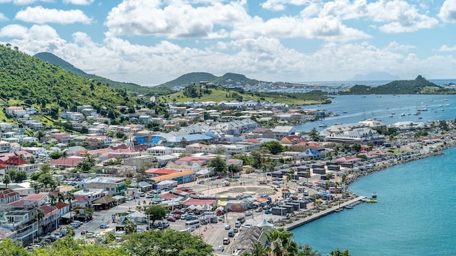 The lush landscape of Saint Martin Island with buildings and mountains The lush landscape of Saint Martin Island with buildings and mountains
