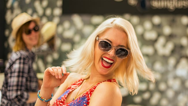 A woman with a sassy expression sports a pair of sun glasses