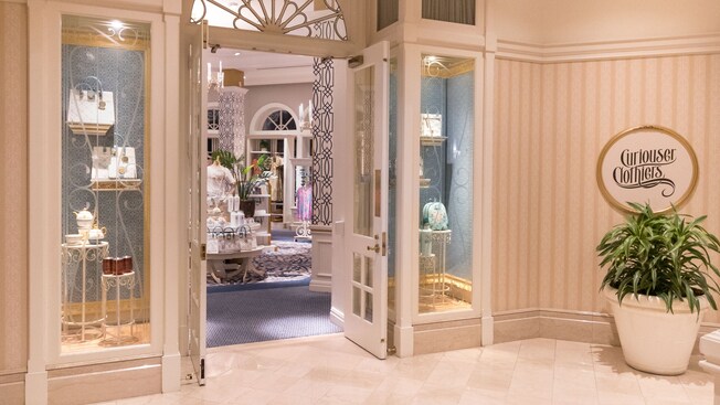 Storefront of Curiouser Clothiers, a clothing store at Disney’s Grand Floridian Resort & Spa