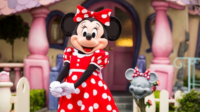 Minnie Mouse strikes a charming pose in front of her home.