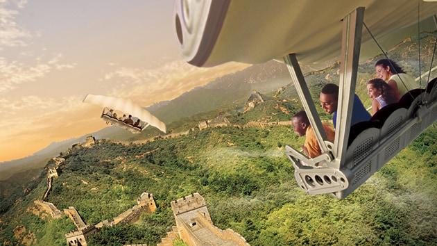 A family of Guests smiles while flying above the Great Wall of China during Soarin' Around the World