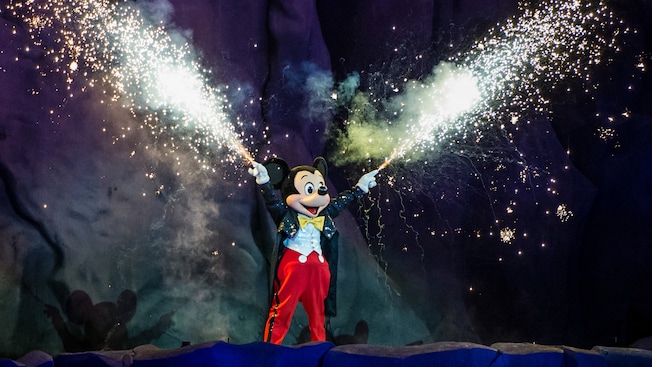 Mickey sets off sparklers in each hand
