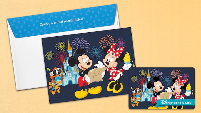 A Disney gift card and matching notecard with a design of Mickey Mouse and Minnie Mouse near Cinderella Castle