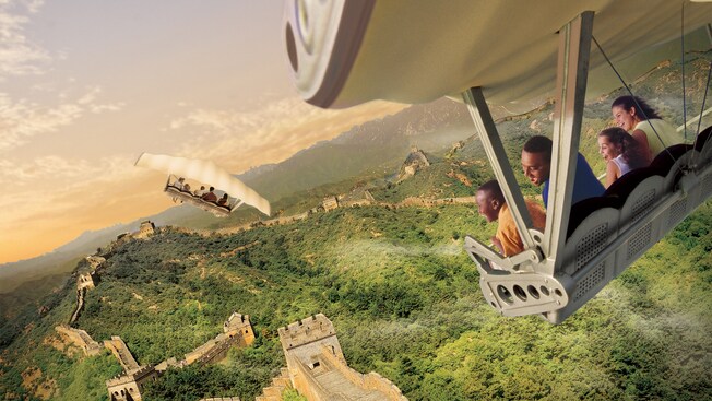 A family of Guests smiles while flying above the Great Wall of China during Soarin’ Around the World