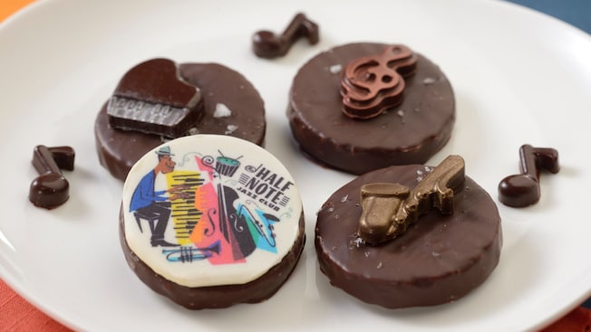 Several chocolate covered pralines, including one decorated with the words Half Note Jazz Club 