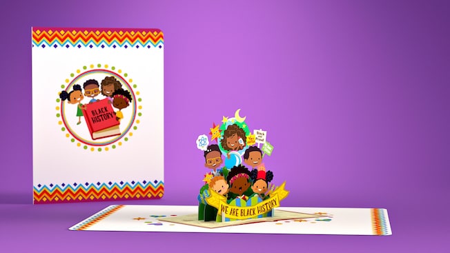 A pop up card that shows 6 smiling people holding a sign that says ‘We Are Black History’