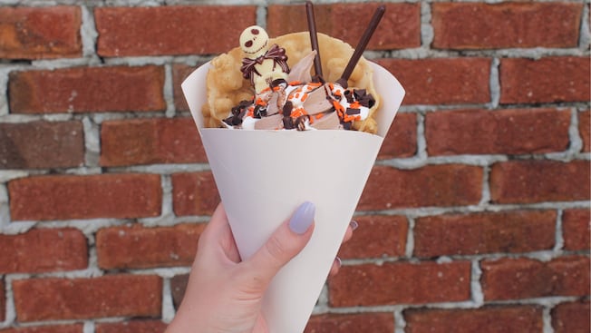 Ice cream served in a bubble waffle, decorated with sprinkles and a Jack Skellington candy