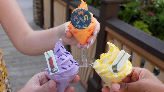 3 soft serve treats in martini glasses, each garnished with a different Hocus Pocus themed candy