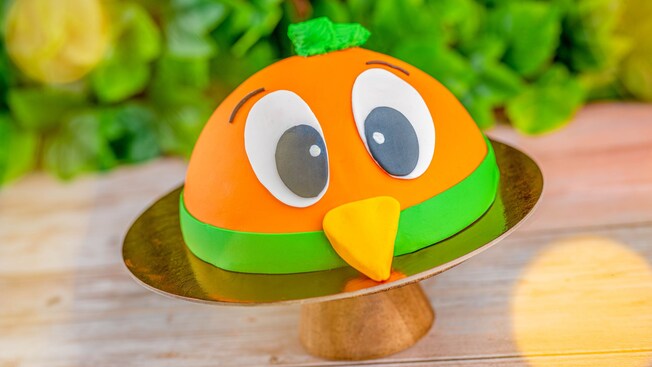 An Orange Bird dome shaped cake on a plate from Amorettes Patisserie