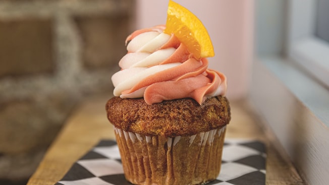 An Orange Blossom Bomb Cupcake with an orange slice on top from Erin McKennas Bakery N Y C