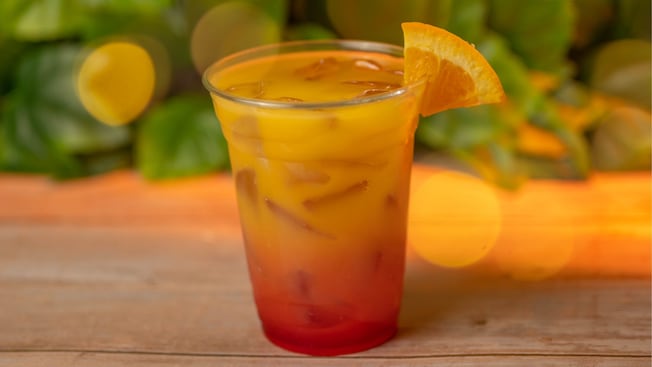 A Tequila Sunrise cocktail with an orange wedge from Outdoor Vending