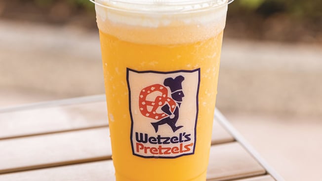 An Orange Dream granita beverage on a table from Wetzels Pretzels