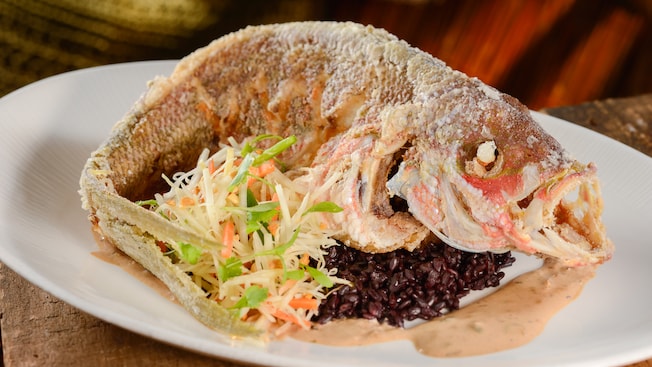 Fried fish paired with rice, sauce and slaw
