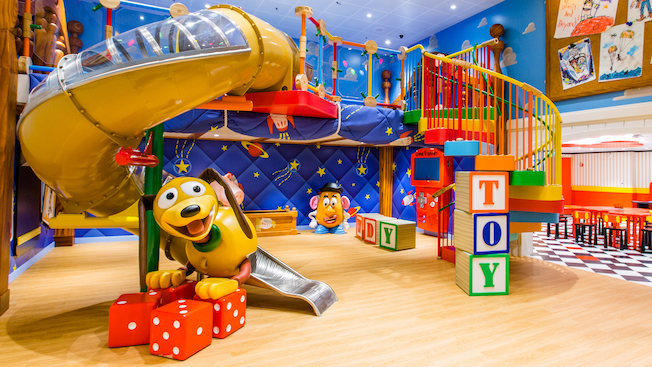 A room themed like the film Toy Story with Mister Potato Head, Slinky Dog and a structure to climb through