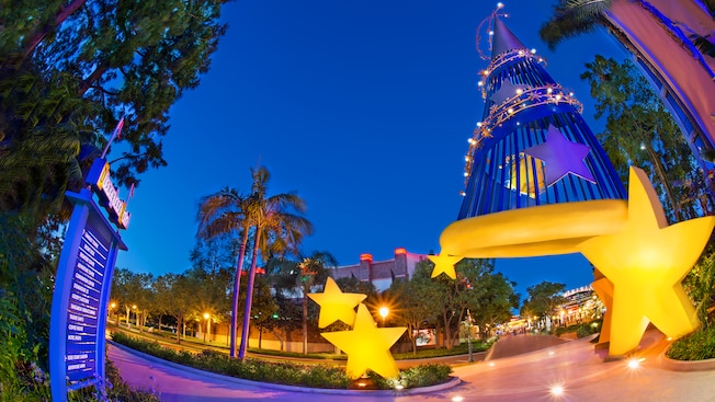 The Sorcerer's Hat sculpture surrounded by stars lights the path to the Downtown Disney District