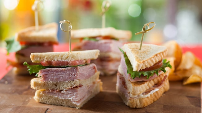 Plaza club sandwich layered with ham, turkey, bacon, lettuce and tomato