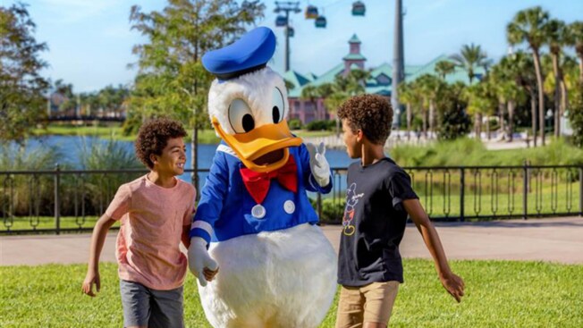 Donald Duck interacting with 2 boys near Disney's Caribbean Beach Resort