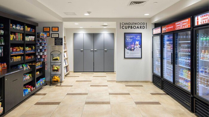 The Candlewood Suites Anaheim Resort Area marketplace featuring shelves with snacks and 4 refrigerators