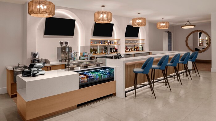 The Bistro restaurant at the Courtyard Marriot in Anaheim, California featuring a counter, chairs, display case and register