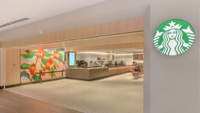 The entrance to Starbucks at the Hilton Anaheim with an illuminated logo on the wall