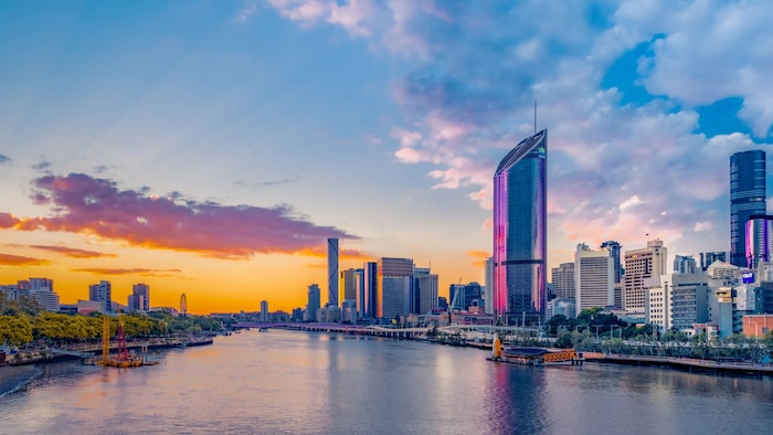 The Brisbane skyline features a river running through a city with tall buildings
