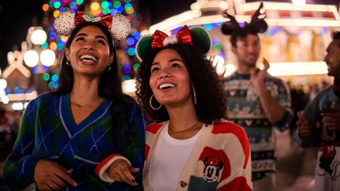 A family of 4 experiencing snowflakes during Holidays at Walt Disney World Resort