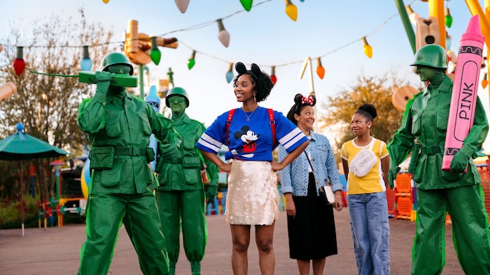 Three Guests posing with 3 Green Army Men in Toy Story Land at Disney’s Hollywood Studios