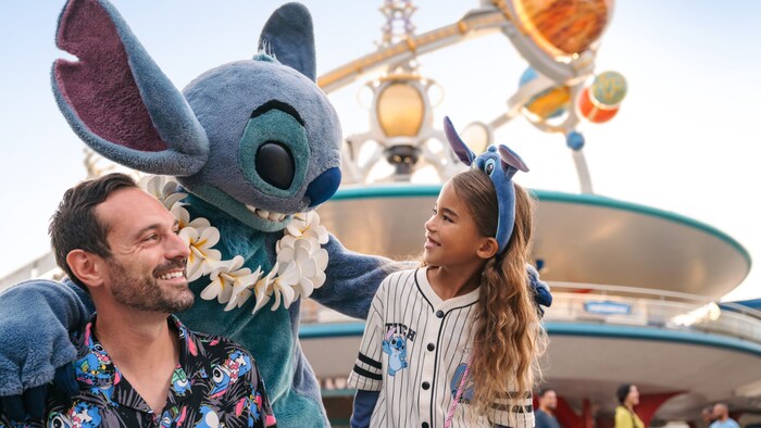 A father and daughter greeting Stitch at Magic Kingdom park